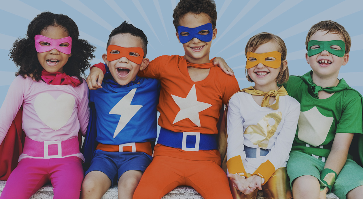 Group of kids wearing superhero costumes