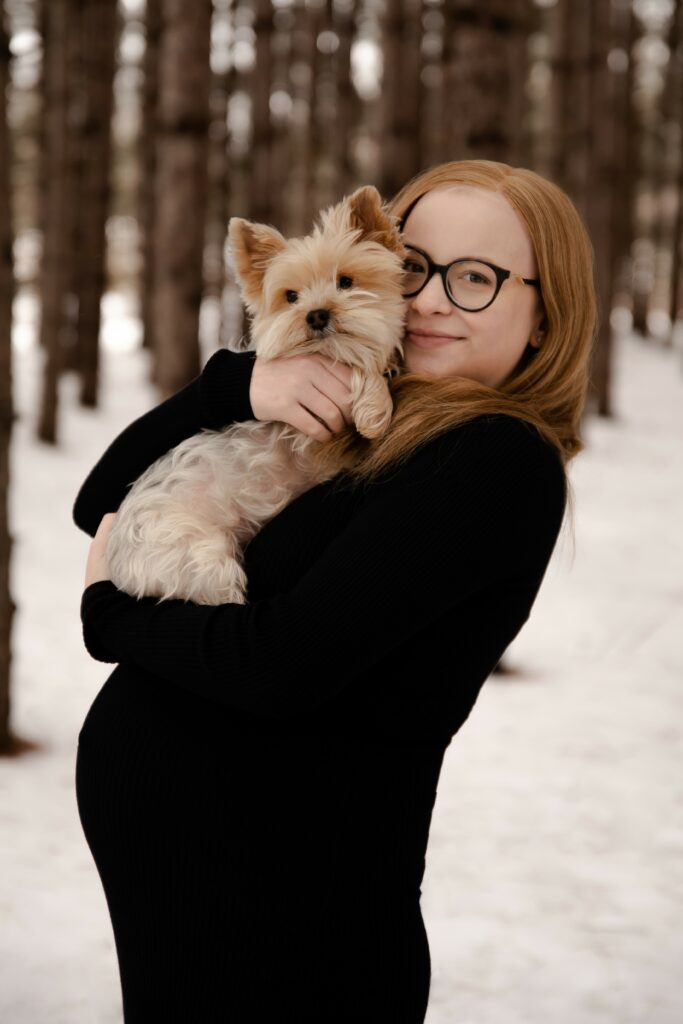 Justine with her dog in her arms