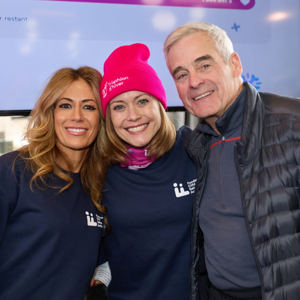 Three people smile at the camera.