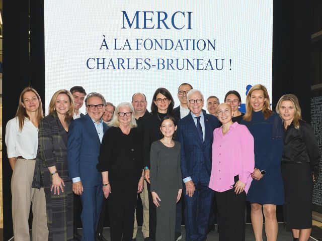 Devant un écran affichant « Merci à la Fondation Charles-Bruneau ! », un groupe d'une quinzaine de personnes sourient en regardant la caméra.