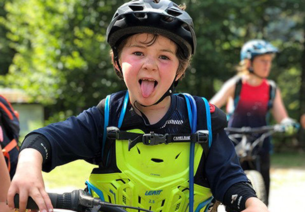 Personne en tenue de cycliste, souriante, lors d&rsquo;une balade &agrave; v&eacute;lo.